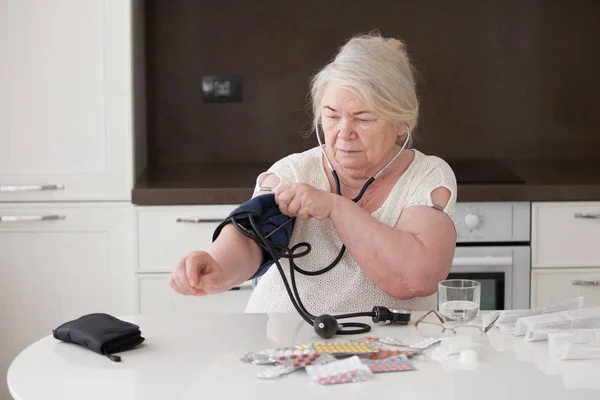 Ældre Kvinde Sætter Tonometer Hendes Arm - Stock-foto