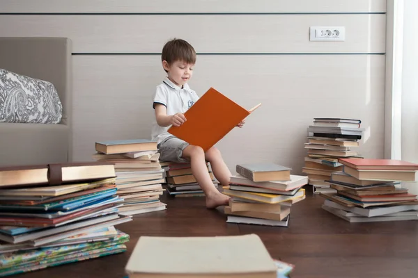 Boy Sits Books Reads Him Many Colorful Books — Stock Photo, Image