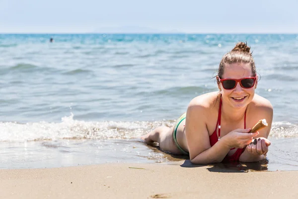 Ragazza con gelato sulla spiaggia del Mar Tirreno nella regione Toscana — Foto Stock