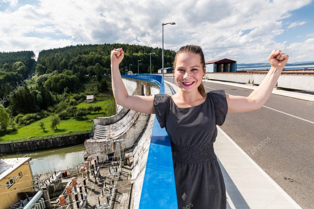 Girl at the concrete dam and hydroelectric plant station in Oravska Priehrada