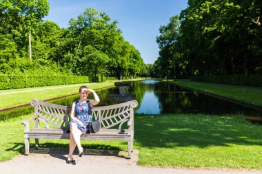 İçinde park De Haar Kalesi Hollanda bankta oturan kız