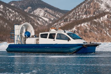 Hovercraft on the ice of lake Baikal, Sandy Bay clipart