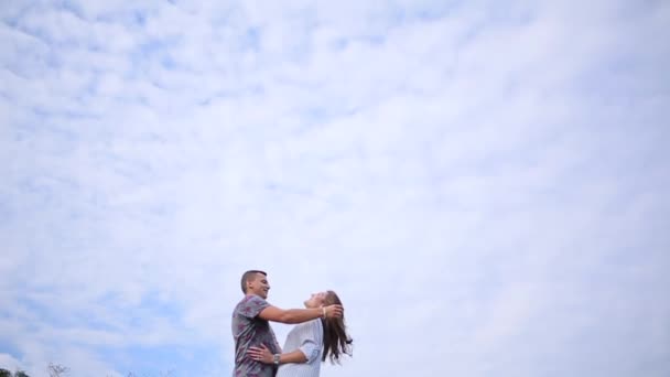 Couple embracing on the sky background — Stock Video