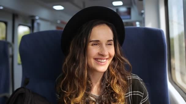 Girl rides on the train and smiling — ストック動画