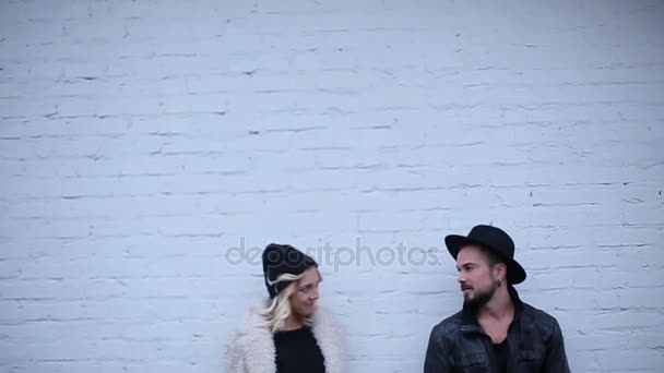 Couple standing at white brick wall background — Stock Video