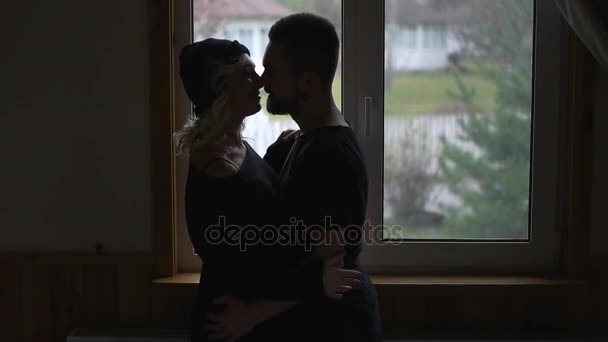 Couple kissing on the background of window — Stock Video