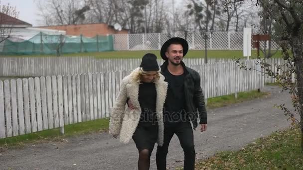 Couple walks in autumn countryside — Stock Video