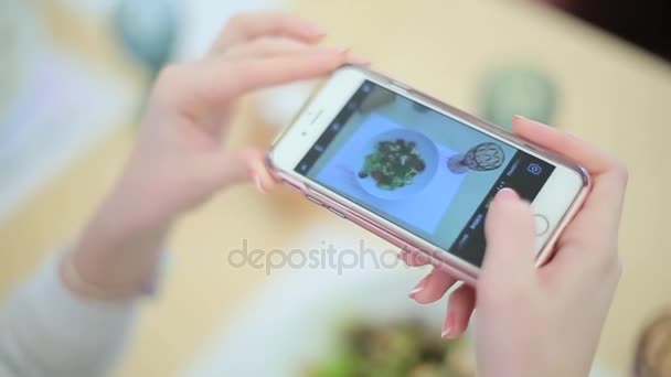 Girl photographing the food on smartphone — Stock Video