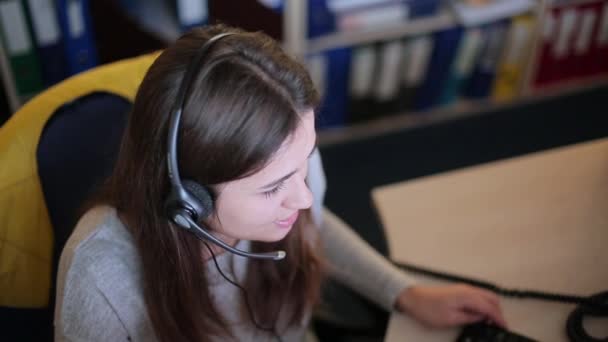 Κορίτσι μιλώντας με έναν πελάτη σε ένα τηλεφωνικό κέντρο — Αρχείο Βίντεο