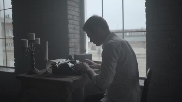 Man typing on retro typewriter in the loft — Stock Video