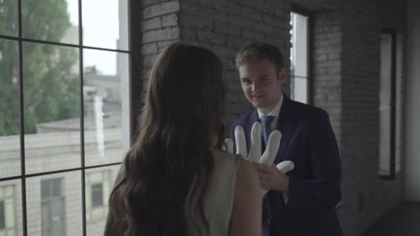 Jongen toont het meisje een grote kunstmatige hand — Stockvideo