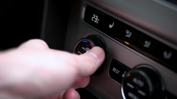 Man sets the air condition temperature in the car — Stock Video