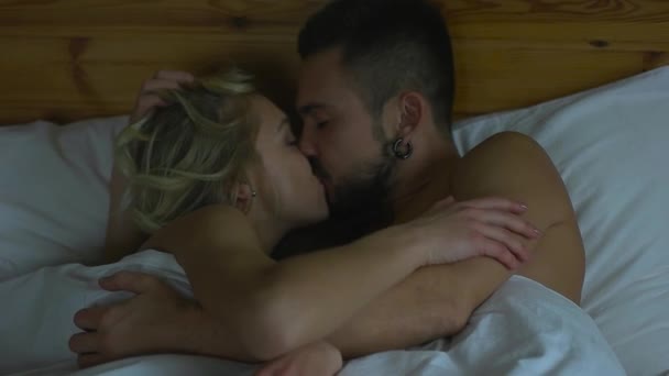 Пара цілується в ліжку — стокове відео