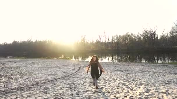 Het meisje wandelingen langs het zand in de buurt van de vijver — Stockvideo