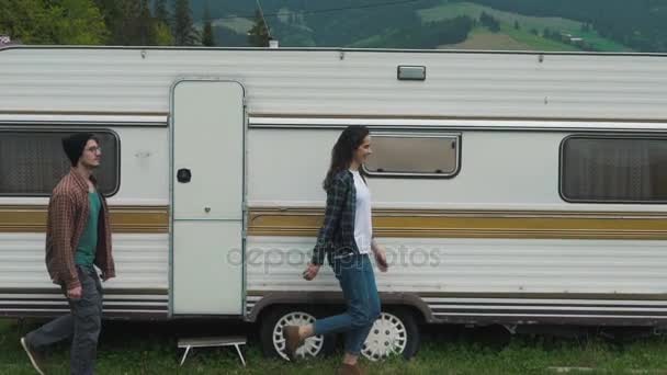 Couple is walking near travel trailer — Stock Video