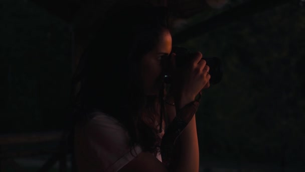 Girl takes photo in the evening forest — Stock Video