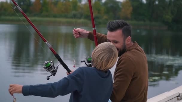 Father and son have fun on fishing — Stock Video