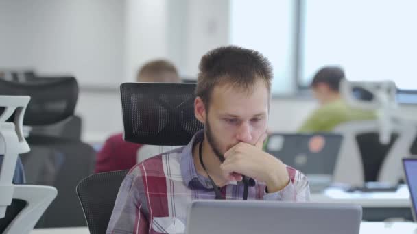 Человек работает на ноутбуке в офисе — стоковое видео