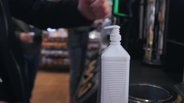 Using dispenser with sanitizer at a gas station — Stock Video