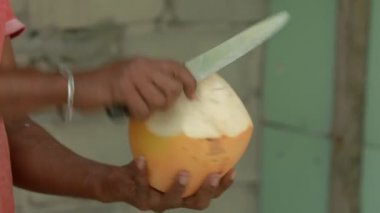 Sarı hindistan cevizi kesen adama yaklaş..