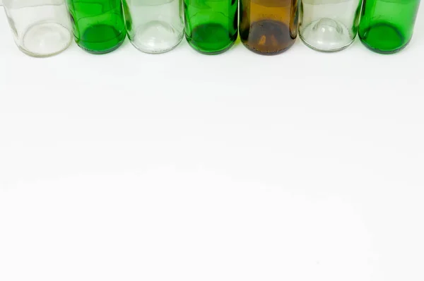 Glass bottles of mixed colors including green, clear white, brow — Stock Photo, Image