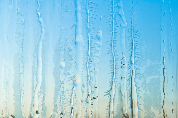 Ice flowers and frost pattern on frosty window glass — Stock Photo, Image