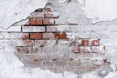 beyaz sıva düştü ile tuğla duvar arka plan. Tuğla duvar beyaz sıva altından görülebilir. Beyaz sıva ve tuğla duvar dokusu. sıva altında tuğla duvar parçası