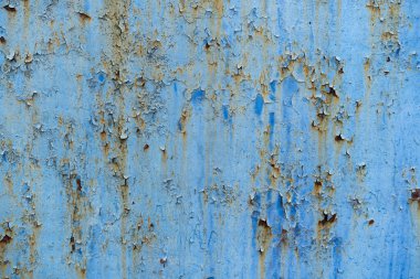 Arka plan mavi renkte soyulan metalik bir yüzey. Eski mavi desen, metalik bir yüzeyi soyan boya..