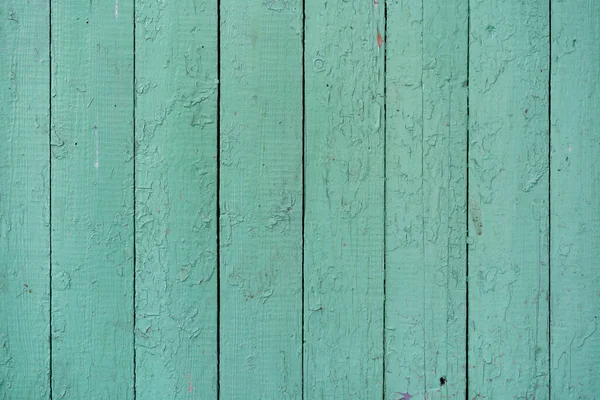 Yeşil boyalı eski ahşap tahtalar. Yeşil boya ahşap tahtalardan dökülecek. Eski ahşap yüzeyi olan yeşil boya