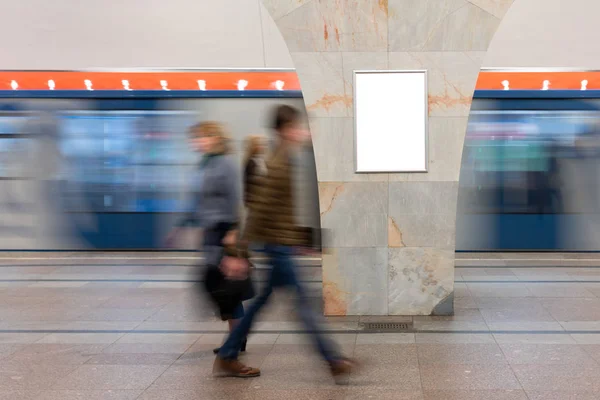 Mock Up Banner, Billboard at metro station. Blurred movement people on background rectangular layout small banner and train movement. Advertising in the subway, large lobby.