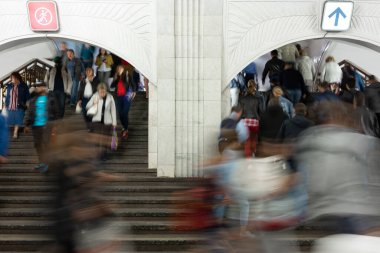 Bulanık hareket. Metroda, tren istasyonunda merdivenlerde bir sürü insan var. İnsanlar büyük salonda merdivenlerden inip çıkıyorlar. Yön insan akışı, kalabalık