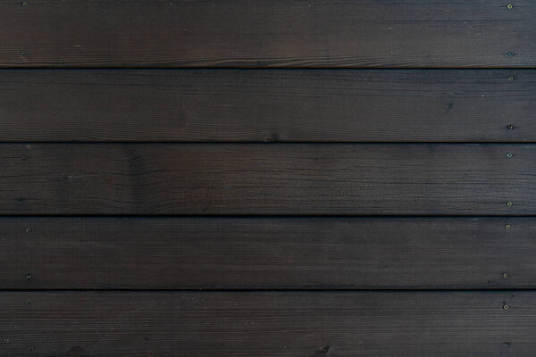 background walls of dark wooden planks, bolted to the screws.
