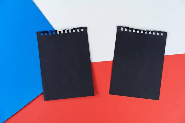 Black list Czech Republic. Mourning, ban, sanctions, politics. black sheet of notebook is on Czech flag. Mock up, copy space, pattern, cardboard texture.