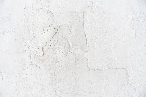 background cracked white wall. White plaster cracked. Cracks on the white wall. Grid on a white plaster wall texture.