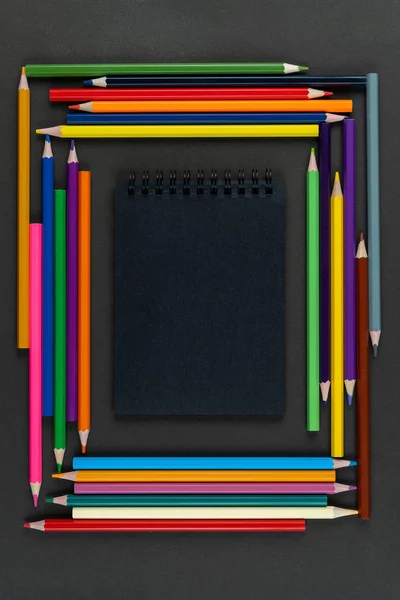 Notebook Preto Quadro Lápis Multicoloridos Fundo Preto Mock Espaço Cópia — Fotografia de Stock