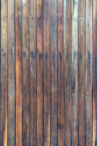 旧的木制栅栏 有腐蚀的木制木板 几块木板的剥皮木门 没有油漆的旧的天然木板 — 图库照片