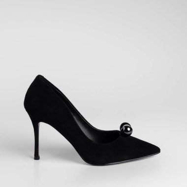 Women black suede heeled shoe with a pearl toe decorative element. Close-up side view studio shot. On a white background for a catalog