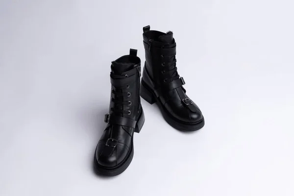 black leather female warm winter boots on a white background. Copy space