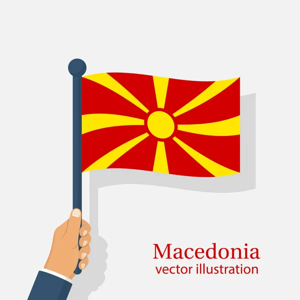 Macedónia bandeira segurando na mão — Vetor de Stock