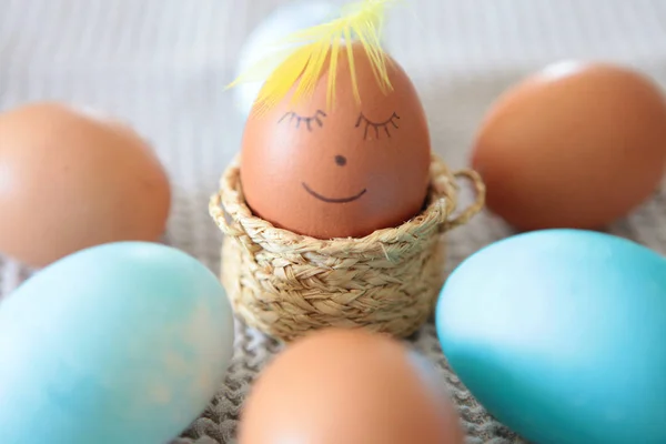 Colorful Easter eggs with smiling emoticon for handpaintings at home. brown eggs face arranged together on the paper background, Selective focus at the eeg. Many colorful organic chicen fresh eggs