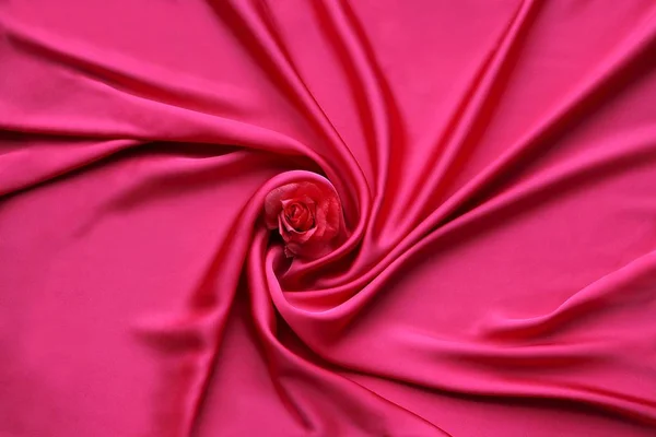 Red Silk And Rose Petals. rose on a silk textured abstract background. Valentines day with copy space for add text.