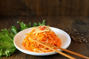 Tahta meşe ağacında çubuklu havuç Kore et salatası.