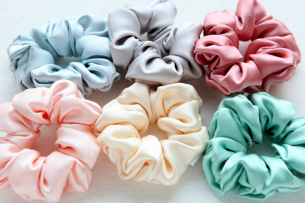 Lot of Colorful silk Scrunchies isolated on white. Flat lay Hairdressing tools and accessories. Hair Scrunchies, Elastic HairBands, Bobble Sports Scrunchie Hairband