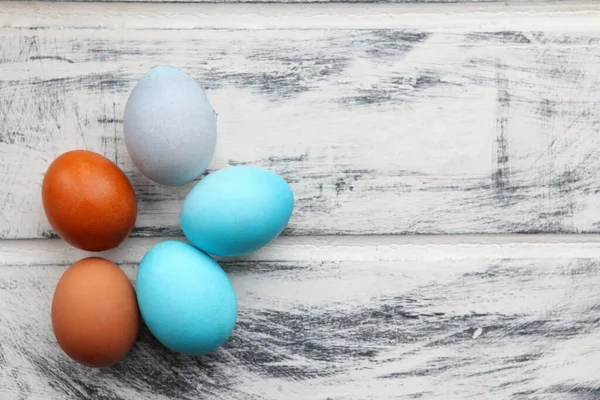 Blue Easter eggs on white painted wooden table background. design template, free copy space. colorful easter eggs