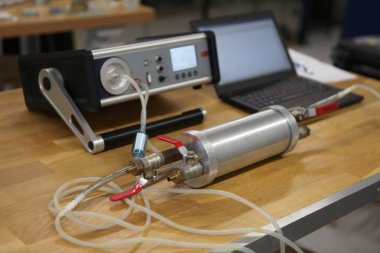 Radon gaz radyasyon detektörleri test ediliyor. Dozimetrist, uzun bir tüp üzerinde taşınabilir gama radyasyon dozimetresi tutuyor.