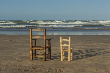 Deniz kıyısı içinde arka görünümü küçük hasır sandalyeleri ayağa kalk