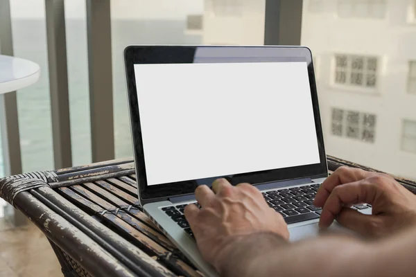 Close up mans hands working with laptop in the terrace.