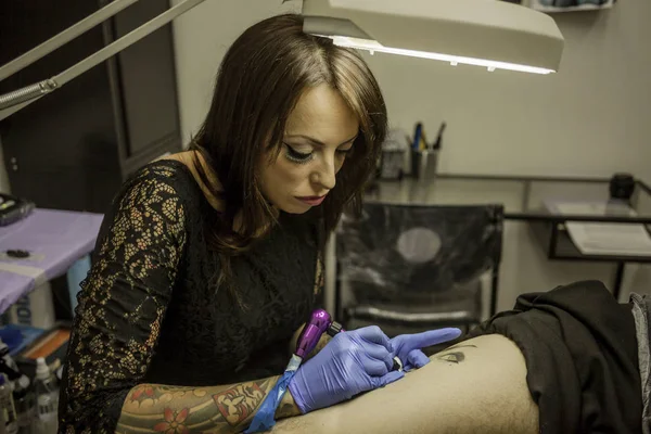 Portrait woman tattoo artist working tattoo
