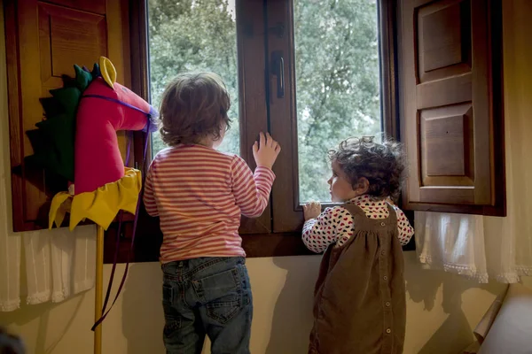 Two girls looking throw the window, waiting for Santa — Stock Photo, Image