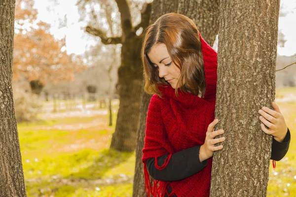 Porträtt vacker ung kvinna som bär röd ull poncho inne d — Stockfoto